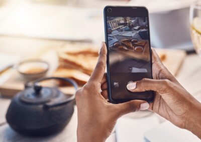 person taking a picture of food on their smartphone